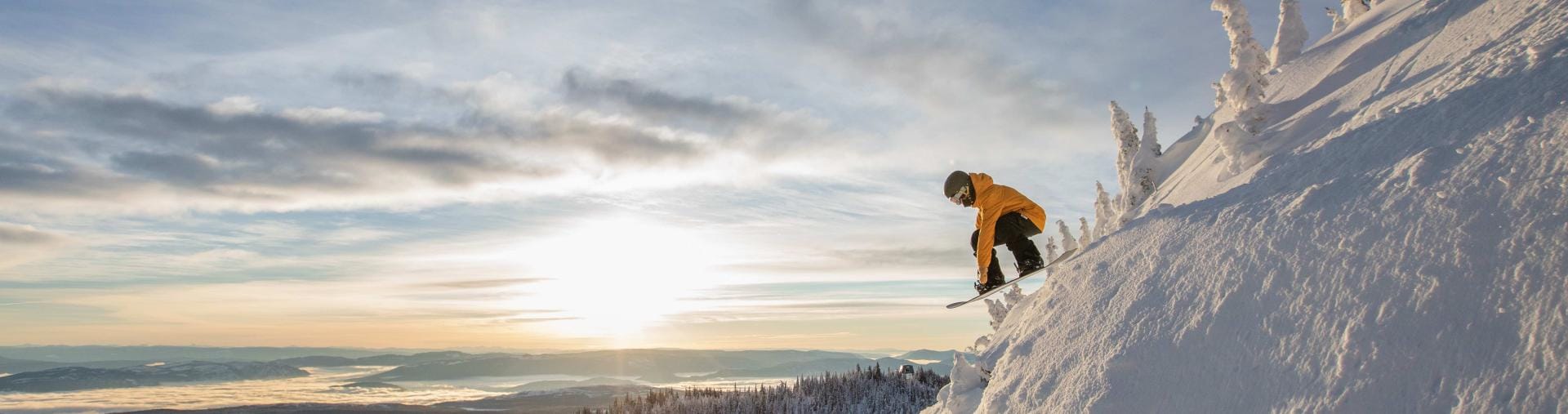 Snowboarder on edge of cliff